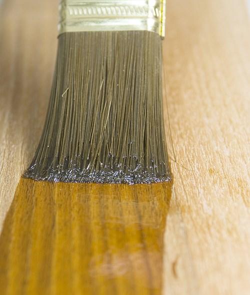 Applying Tung Oil with a brush.