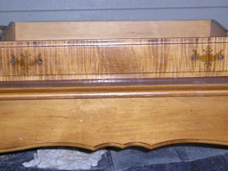 Faded stain and finish on a solid wood coffee table.