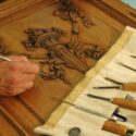 Skilled craftsman restoring a piece of furniture.