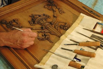 Skilled craftsman restoring a piece of furniture.