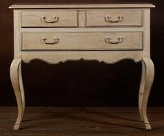 An old creamy white dresser with brown glaze.