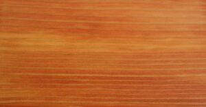 A red wood dye applied to straight grain fir.