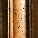 Real woodworm holes in an antique French Armoire.