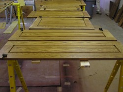 Refinishing kitchen cabinet doors.