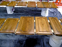 Refinishing kitchen cabinet doors.