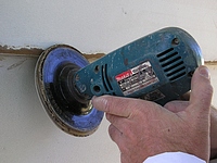 Using a disk sander on masonite siding.