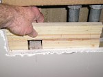 Installing a piece of 1x6 as a furring strip/backing for new drywall.