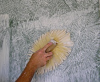 Using a drywall texture brush to stomp the texure.