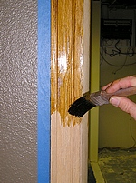 Staining wood with a brush.