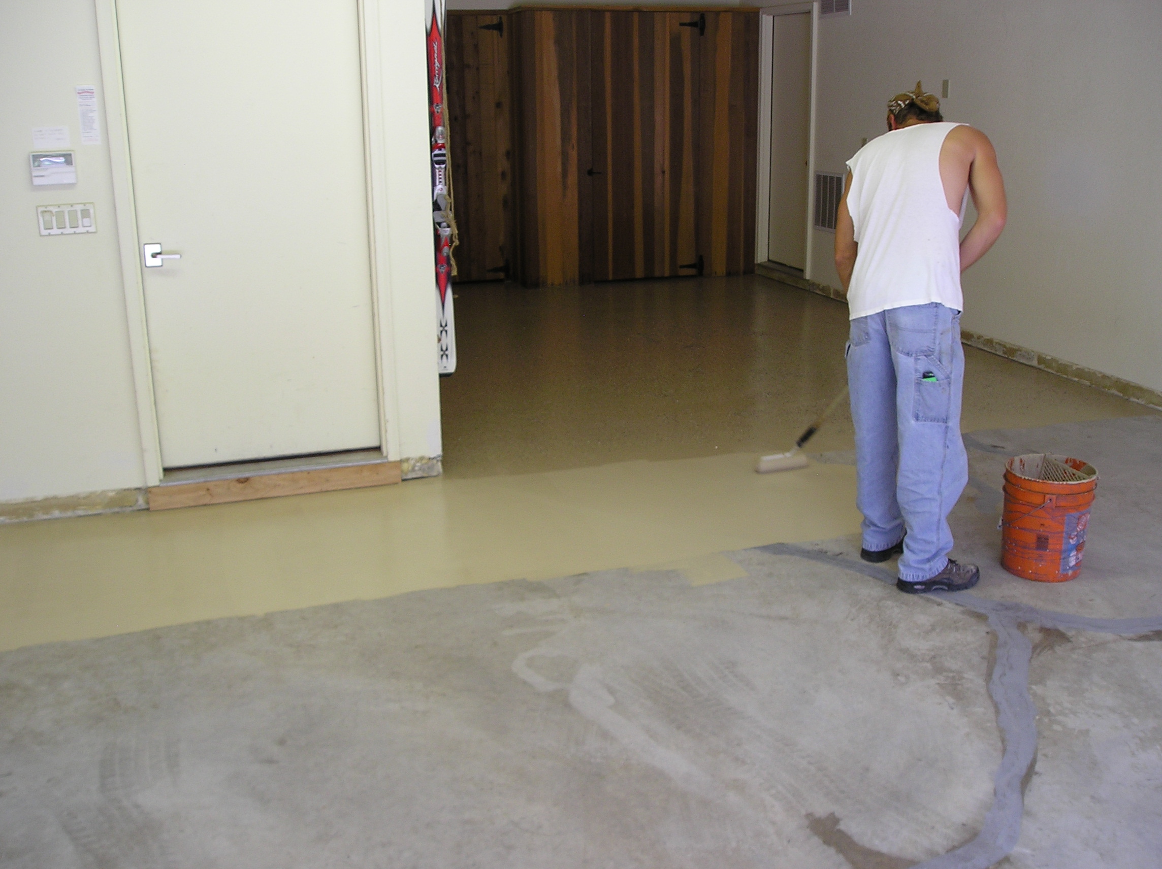 Painting a garage floor with 2-part epoxy.