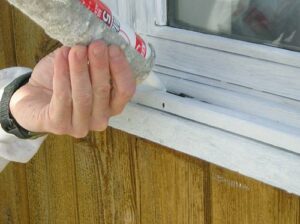 Caulking an old Oldach wood window.