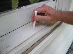 Testing a window sill for lead paint.