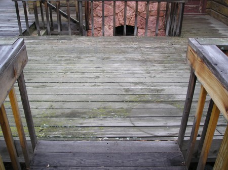 A very old worn wood deck in desperate need of refinishing.