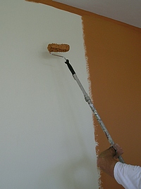 Using a paint roller pole on a tall wall.