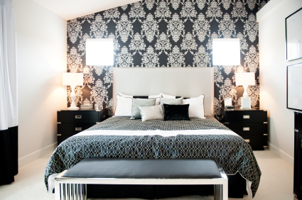 A stylish bedroom with a wallpapered wall as an accent.