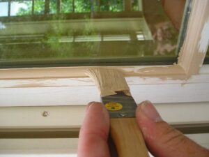 Painting an exterior wood window sash.