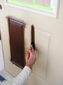 Applying gel stain to the raised panels of a fiberglass door.