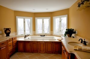 Spacious bright master bathroom paint with a gold walls and a white ceiling.