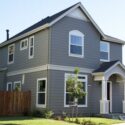 A freshly painted home using gray for the siding and white for the trim.