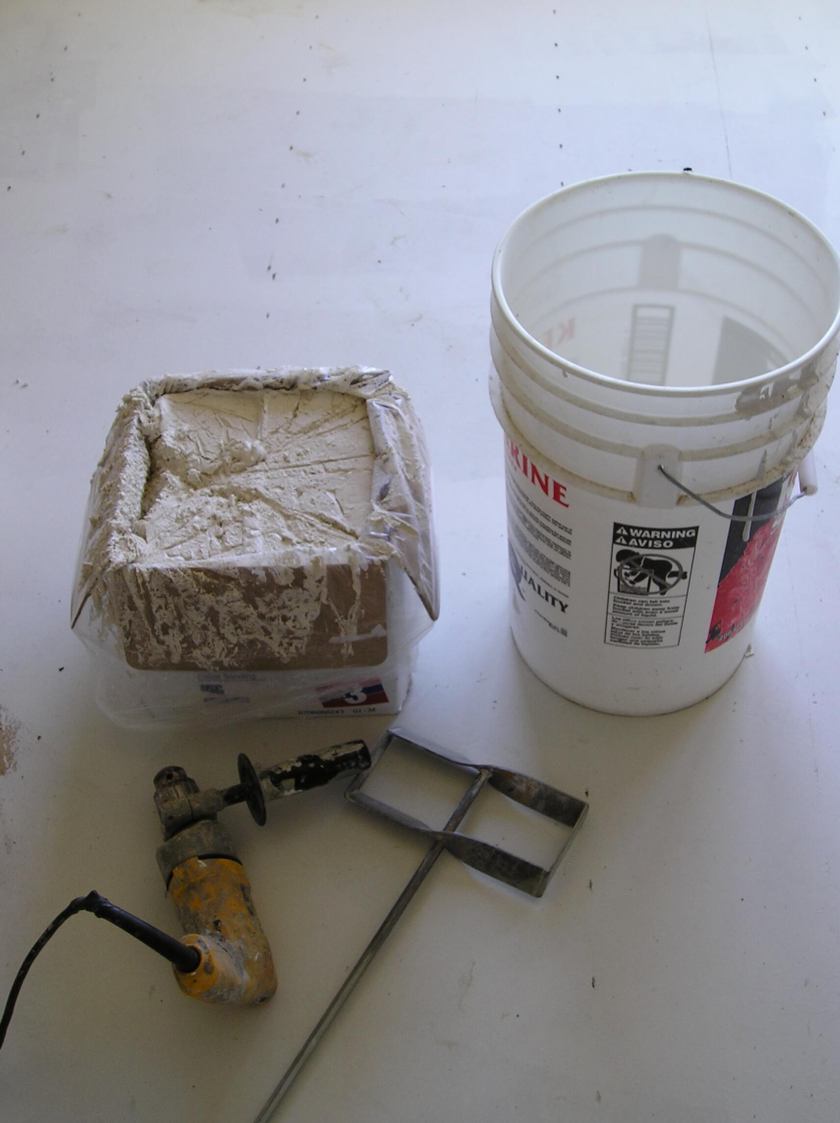 Mixing drywall compound, getting ready to apply a knockdown texture.