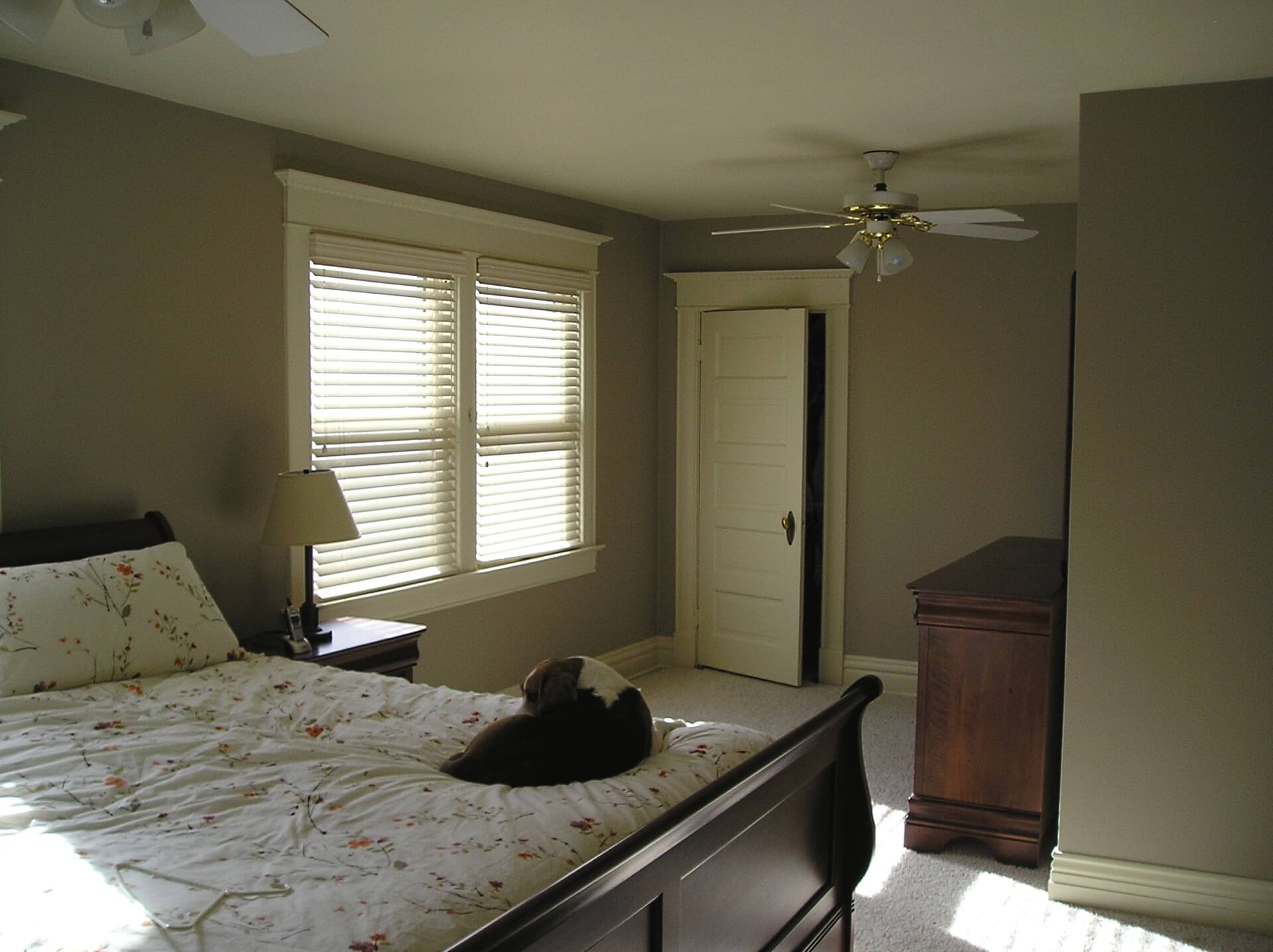 A bedroom painted with a white ceiling and neutral greige color on the walls.