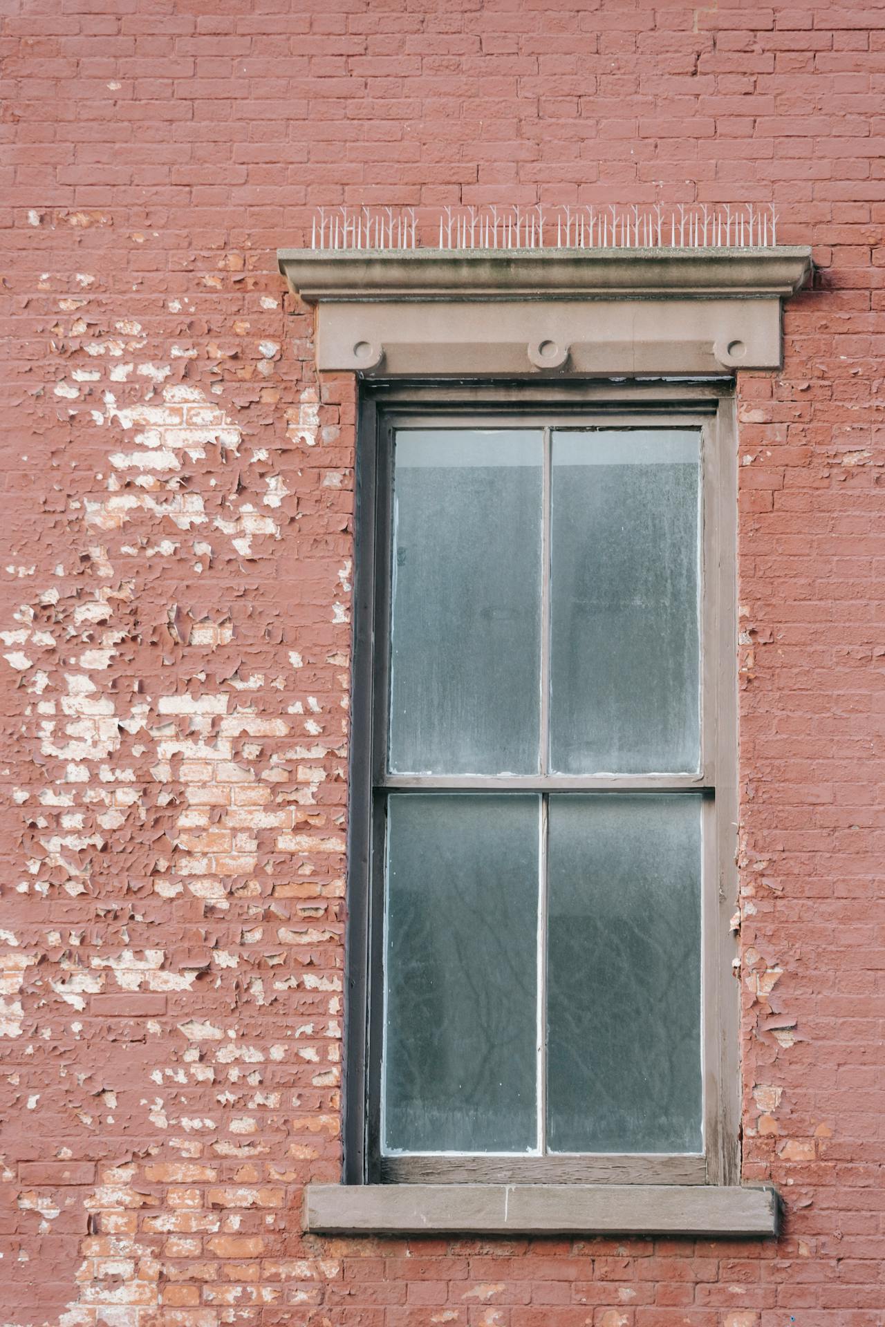 Exterior fasaude of peeling painted brick.