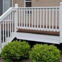 A freshly refinished wood deck with stained floor and painted handrail.