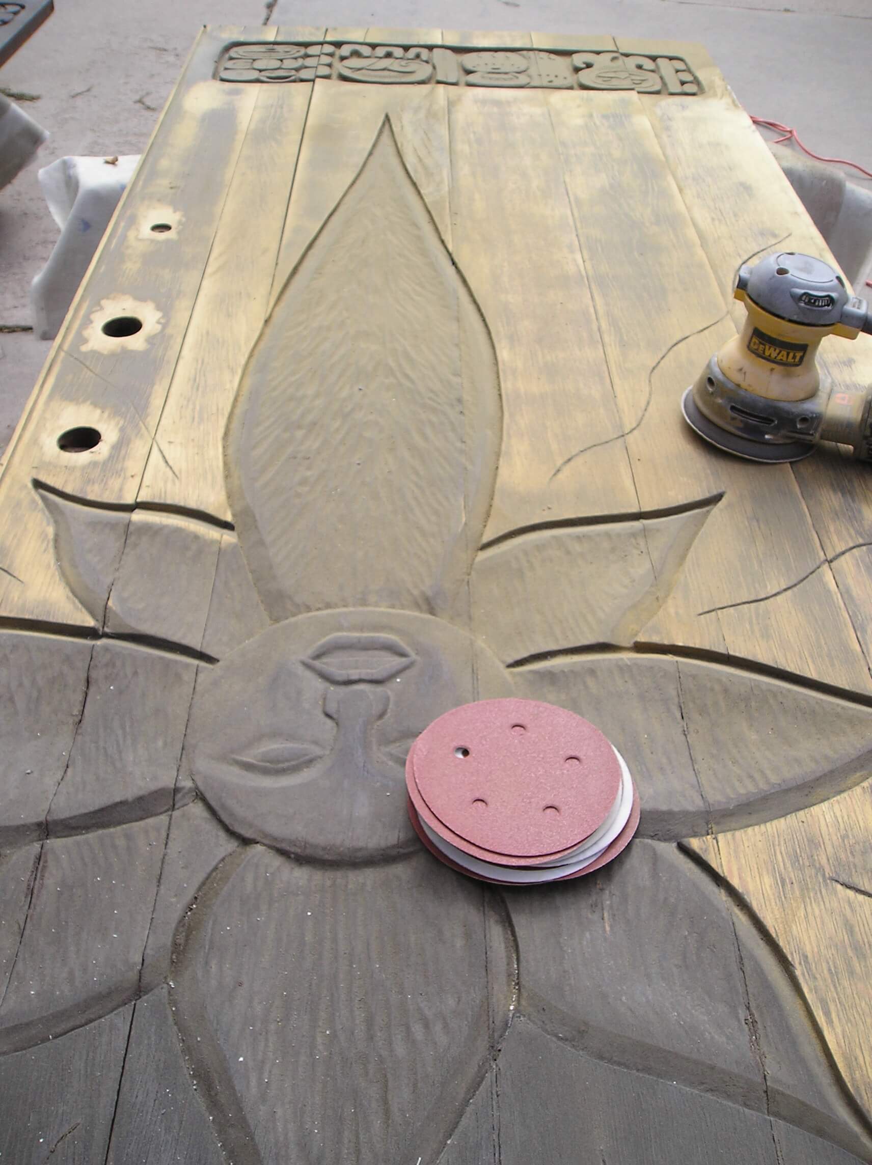 Using a orbital sander on a wood door.