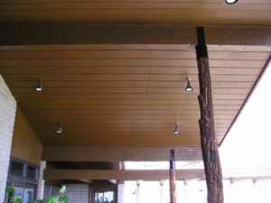 Exterior wood soffit sprayed with a semi-solid wood stain.