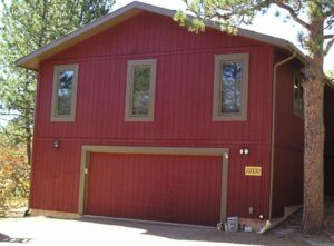 T1-11 siding house stained with a solid colored exterior wood stain.