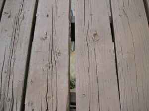 Old cracked and split wood deck boards.