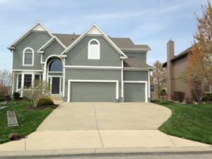 A home painted with grey siding and white trim.