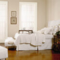 A white painted bedroom decorated in a cottage style.