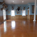 Orange stained concrete floor with gloss finish.