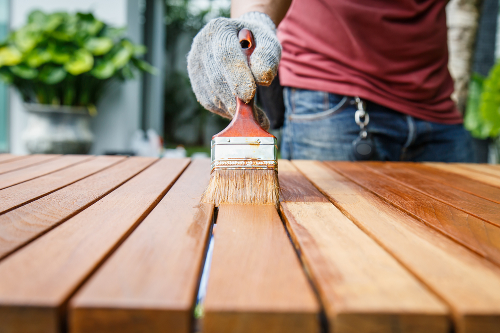 Applying paint with a brush.