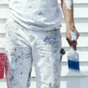 A house painter with bucket and paint brush.