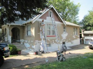 House's exterior being prepared for painting.