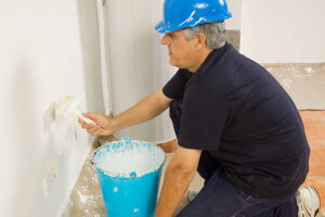 painting the wall of the house by a painter